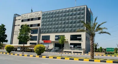 Faisal Mansion commercial building in Faisal Town Phase 2 Islamabad with modern architecture and landscaped surroundings.