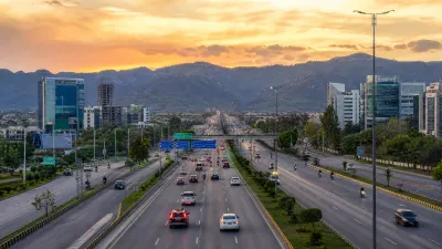 Wide-angle professional shot of the Islamabad Expressway at sunset, showcasing modern commercial connectivity and infrastructure growth in the capital.