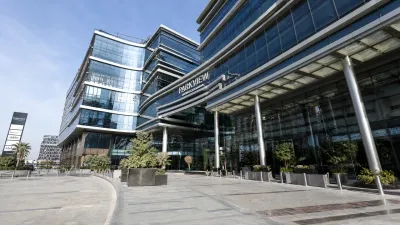 Professional architectural photograph of a high-end modern glass-and-steel commercial plaza in Islamabad, highlighting enterprise-grade development and scale.