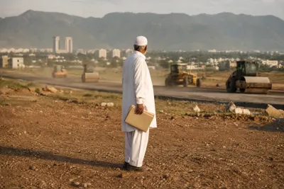 E-12 Islamabad allottee holding his property file on an unfinished plot as CDA road construction machinery works in the background