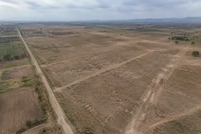 "Aerial view of undeveloped land with boundary markers in rural Pakistan"