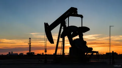 Oil pumpjack silhouetted at sunset, representing falling global oil prices and their potential impact on Pakistan’s construction costs.