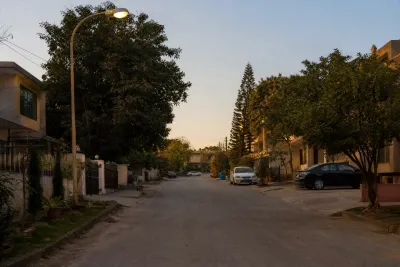 Paved residential street with double storey houses and street lighting in an established Islamabad government housing sector.