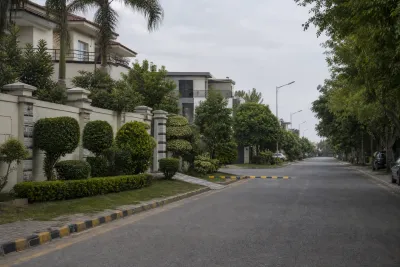 Fully built gated residential street in DHA Islamabad-Rawalpindi with landscaped verges, mature trees and established housing.