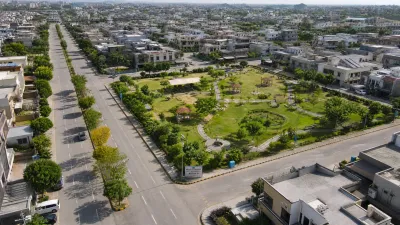 Aerial view of houses, paved streets, and parks in Multi Gardens B-17 Block B.