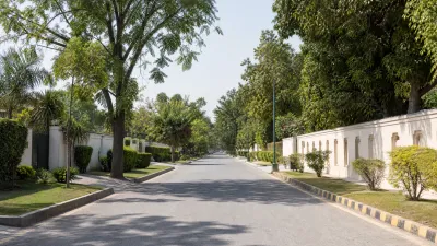 ree-lined boulevard with whitewashed boundary walls typical of a Rawalpindi cantonment residential street.
