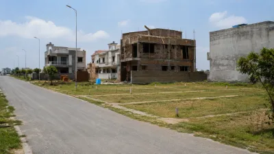 Vacant demarcated plots alongside houses under construction indicating genuine possession readiness