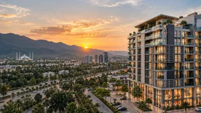 Modern apartment tower overlooking Islamabad at sunset with Margalla Hills in the background.